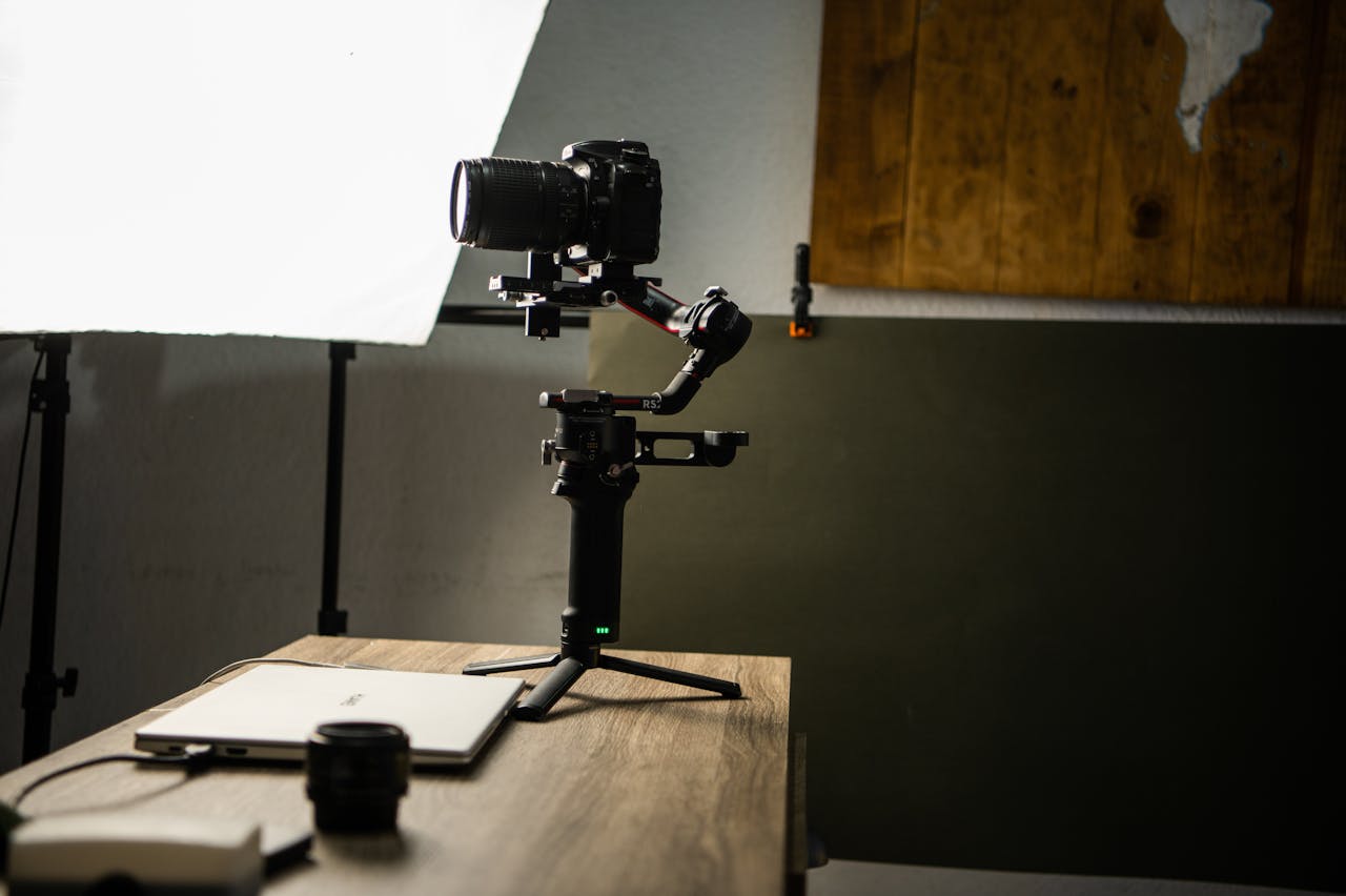 DSLR camera on gimbal setup in a well-lit photography studio with wooden accents.